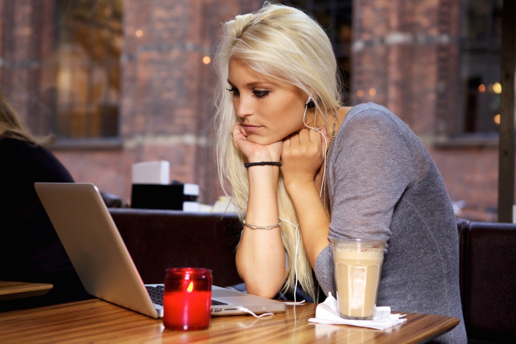 Woman with laptop on cafe